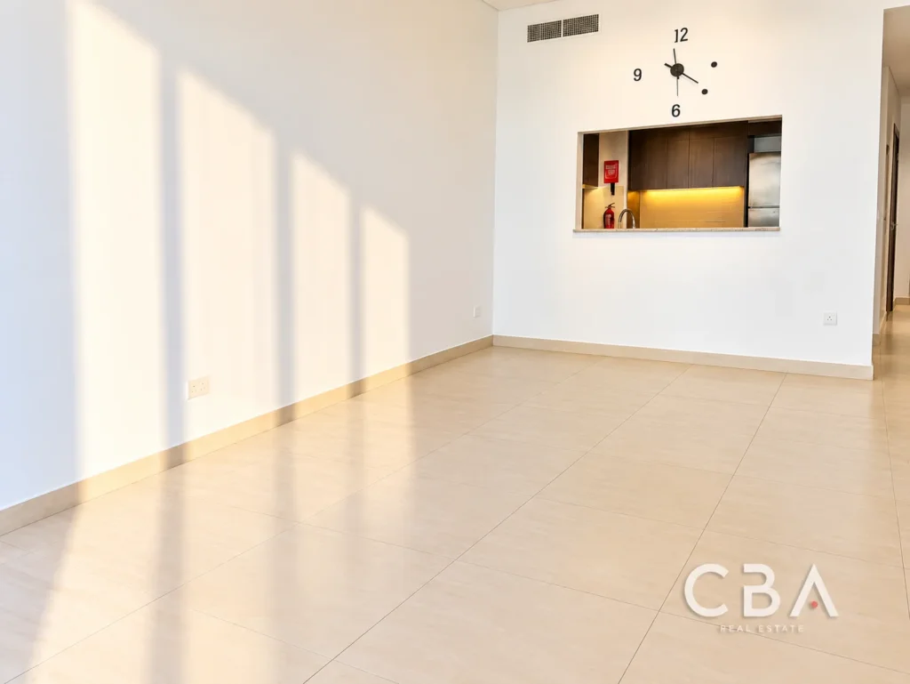 Sunlit Empty Apartment with Kitchen Pass-Through