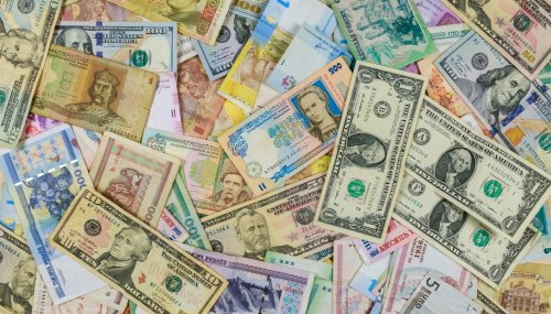 International currencies banknotes from different countries overlapping each other