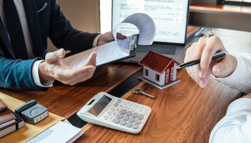 Real estate agent are presenting home loan and sending keys to customer after signing contract to buy house with approved property application form, Insurance Home concept.